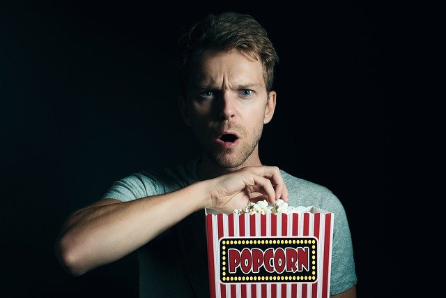 man with popcorn box