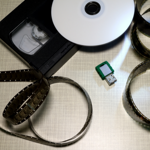 film, vhs tape, and cd with a flash drive
