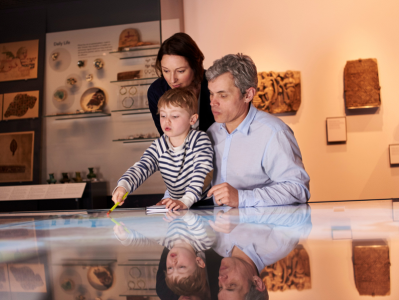 family looking at a museum case